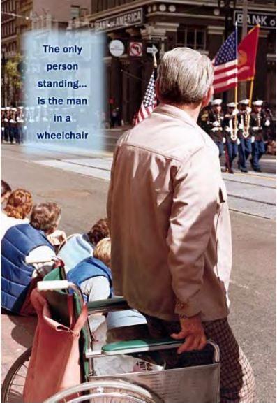 Man in wheelchair standing.JPG