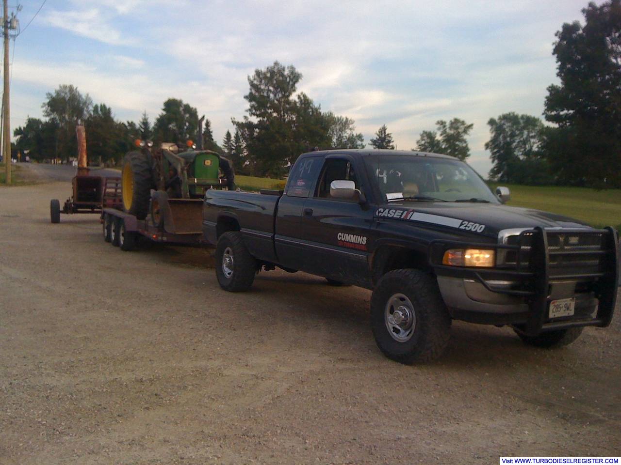 1997_dodge_hauling_a_tractor_and_chipper